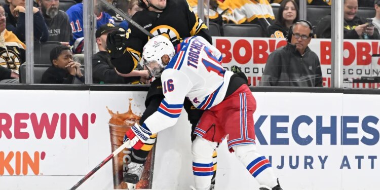 New York Rangers center Vincent Trocheck checks Boston Bruins defenseman Andrew Peeke into the boards.