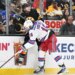 New York Rangers center Vincent Trocheck checks Boston Bruins defenseman Andrew Peeke into the boards.
