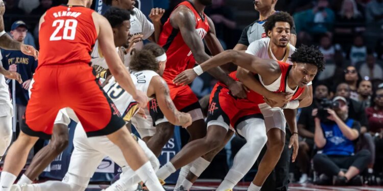 New Orleans Pelicans guard Jose Alvarado (15) and Houston Rockets guard-forward Amen Thompson (1) are pulled apart after a skirmish during an NBA preseason game at Legacy Arena at BJCC.