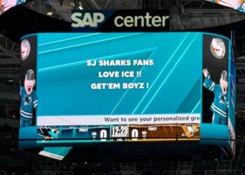 The San Jose Sharks Jumbotron displaying "SJ SHARKS FANS LOVE ICE!! GET'EM BOYZ!"