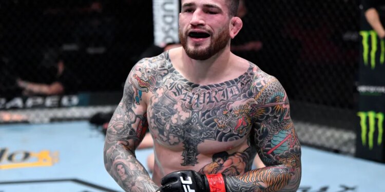 Tattooed fighter Brady in the UFC octagon with a bruised eye and black mouthguard.