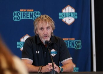 Pascal Daoust, general manager for the New York Sirens, speaks into a microphone at a press conference.