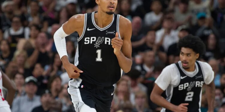 Jeremy Sochan of the Spurs dribbling the basketball.