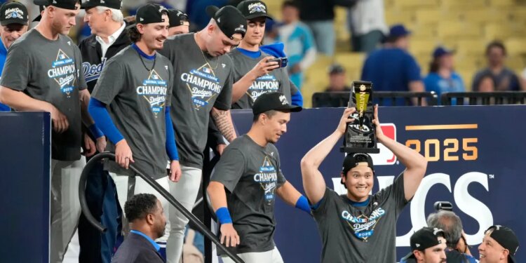 Los Angeles Dodgers' Shohei Ohtani celebrates the National League trophy.