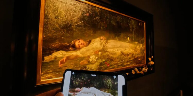 Mobile phone displaying Taylor Swift's "The Fate of Ophelia" video in front of Friedrich Heyser's painting of Ophelia
