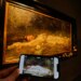 Mobile phone displaying Taylor Swift's "The Fate of Ophelia" video in front of Friedrich Heyser's painting of Ophelia