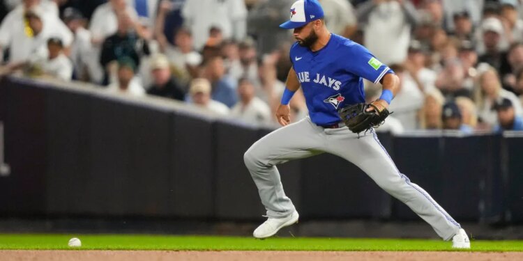 A ground ball hit by New York Yankees Ben Rice gets away from Toronto Blue Jays second baseman Isiah Kiner-Falefa during Game 3 of the ALDS on Oct. 7, 2025.