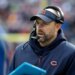 Matt Nagy wearing a Bears visor and headset while holding a Microsoft Surface tablet.