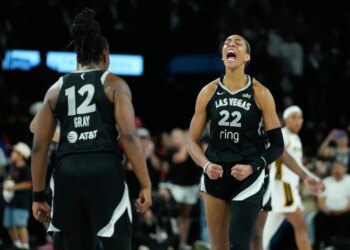 A'ja Wilson of the Las Vegas Aces in an emotional outburst with Jackie Young #23 visible in the background.