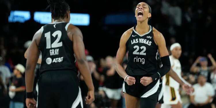 A'ja Wilson of the Las Vegas Aces in an emotional outburst with Jackie Young #23 visible in the background.