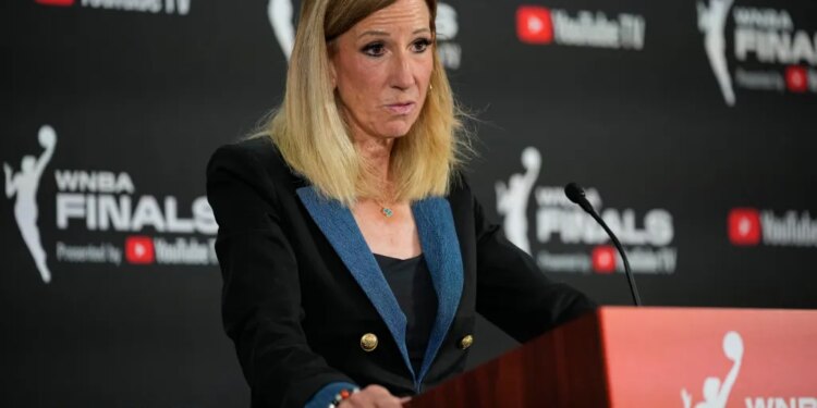 WNBA Commissioner Cathy Engelbert speaks at a podium.