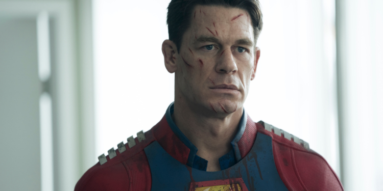 John Cena as Peacemaker, with cuts on his face and bloodstains on his costume.
