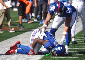Wide receiver Malik Nabers #1 of the New York Giants jumps for a reception and falls behind cornerback Cam Hart #20 of the Los Angeles Chargers. Nabers is injured on the play during the first half when the New York Giants played the Los Angeles Chargers Sunday, September 28, 2025 at MetLife Stadium in East Rutherford, NJ.