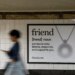 Photo of Friend ad in new york city subway as a blurred person walks past it.