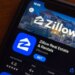 Closeup of the Zillow app page in the App Store on an iPhone screen.