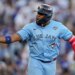 Toronto Blue Jays player in a light blue jersey, batting helmet, and a World Series patch.