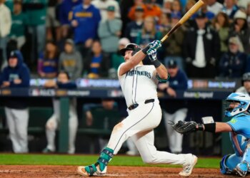 Seattle Mariners catcher Cal Raleigh hitting a solo home run against the Toronto Blue Jays.