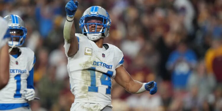 Amon-Ra St. Brown of the Detroit Lions celebrates a touchdown.