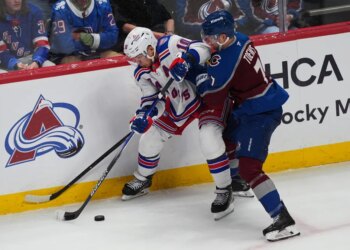 Artemi Panarin struggles to control the puck as he battles Devon Toews for possession during the Rangers' 6-3 loss to the Avalanche on Nov. 20, 2025 in Denver.