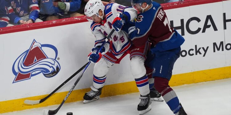 Artemi Panarin struggles to control the puck as he battles Devon Toews for possession during the Rangers' 6-3 loss to the Avalanche on Nov. 20, 2025 in Denver.