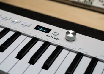 Close up of the Arturia logo alongside the new endless encoder and OLED on the KeyStep mk2.