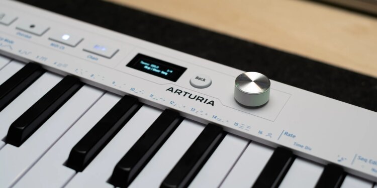 Close up of the Arturia logo alongside the new endless encoder and OLED on the KeyStep mk2.