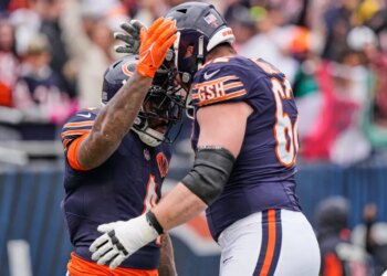Two Chicago Bears football players high-fiving.
