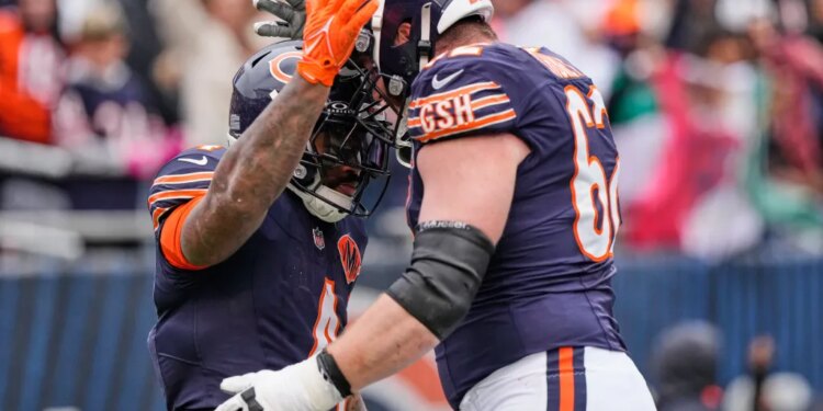Two Chicago Bears football players high-fiving.