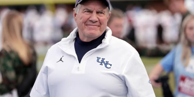North Carolina head coach Bill Belichick smiles on the sidelines.