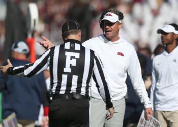 Mississippi Rebels head coach Lane Kiffin talks with an official during the game.