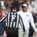 Mississippi Rebels head coach Lane Kiffin talks with an official during the game.