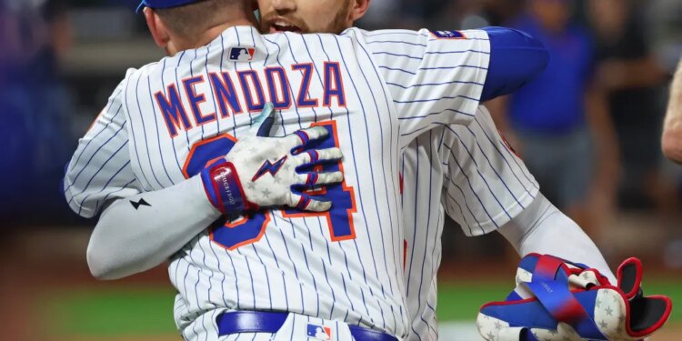 Mets outfielder Brandon Nimmo (9) wins the game with a walk-off hit during the ninth inning and hugs New York Mets manager Carlos Mendoza (64).