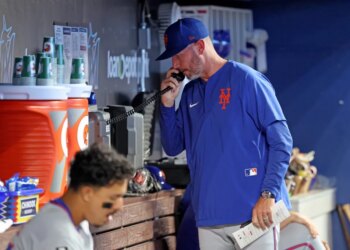 New York Mets pitching coach Jeremy Hefner on the bullpen phone during the 8th inning.
