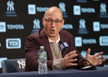 New York Yankees GM Brian Cashman speaking at a press conference at Yankee Stadium.