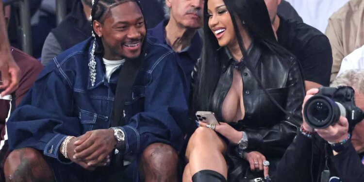 Rapper Cardi B and NFL player Stefon Diggs sitting courtside during an NBA playoff game.