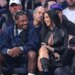 Rapper Cardi B and NFL player Stefon Diggs sitting courtside during an NBA playoff game.