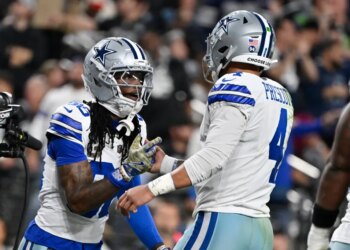 Dallas Cowboys wide receiver CeeDee Lamb celebrates with quarterback Dak Prescott.