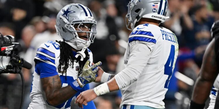 Dallas Cowboys wide receiver CeeDee Lamb celebrates with quarterback Dak Prescott.