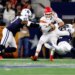 Kansas City Chiefs quarterback Patrick Mahomes is sacked by Dallas Cowboys defensive end Jadeveon Clowney, with Cowboys defensive tackle Osa Odighizuwa also watching.