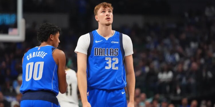 Dallas Mavericks forward Cooper Flagg (32) looks up as teammate Max Christie (00) walks past.
