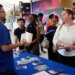 Job seekers listening to Logan Reed, a talent acquisition coordinator for Princess Cruise Line, at a job fair.