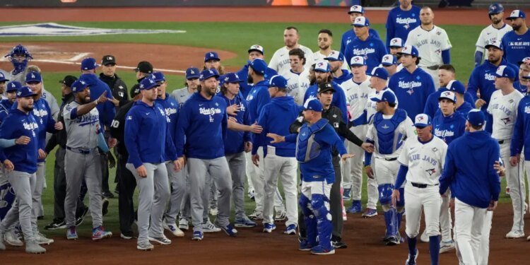 The Los Angeles Dodgers and the Toronto Blue Jays benches clearing after Blue Jays' Andrés Giménez was hit by a pitch.
