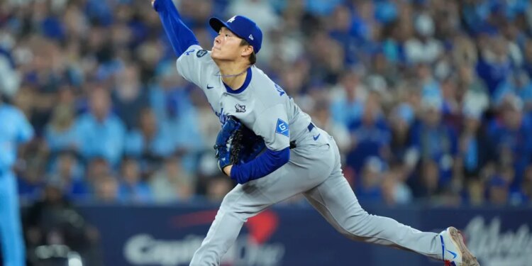 Los Angeles Dodgers pitcher Yoshinobu Yamamoto (18) pitches against the Toronto Blue Jays in the sixth inning during game six of the 2025 MLB World Series at Rogers Centre.