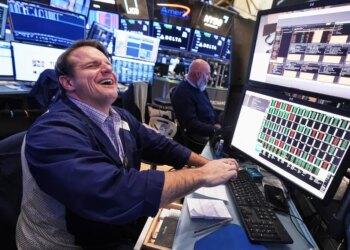 Trader Michael Milano laughing on the floor of the New York Stock Exchange.
