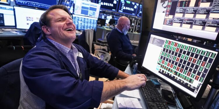 Trader Michael Milano laughing on the floor of the New York Stock Exchange.