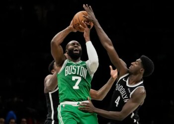 Boston Celtics guard Jaylen Brown (7) attempts to pass away from Brooklyn Nets guard Drake Powell (4) during the second half of an NBA basketball game, Tuesday, Nov. 18, 2025, in New York.