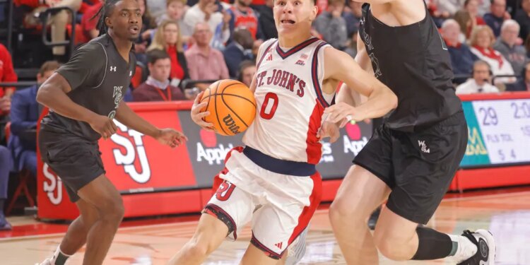 Dylan Darling (number 0) of St. John's Red Storm driving to the basket during a game against William & Mary Tribe.