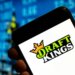 Illustration of the DraftKings logo displayed on a smartphone screen.