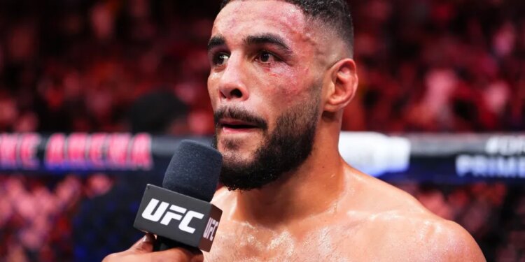 UFC fighter faces a microphone during the Thompson v Bonfim fight.