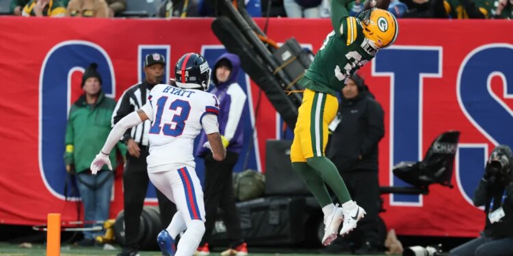 Green Bay Packers safety Evan Williams (33) intercepts a pass intended for New York Giants wide receiver Jalin Hyatt (13) in the end zone.
